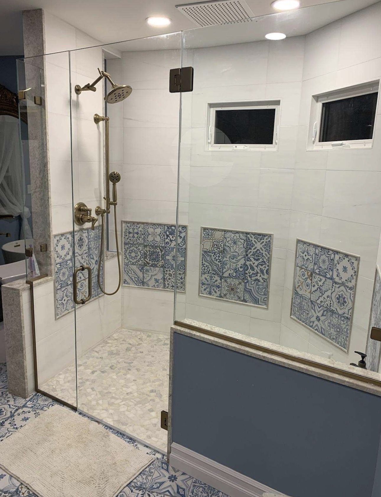 Technical view of a luxury curbless shower installation in Berlin CT featuring orange Schluter-Kerdi waterproofing membrane